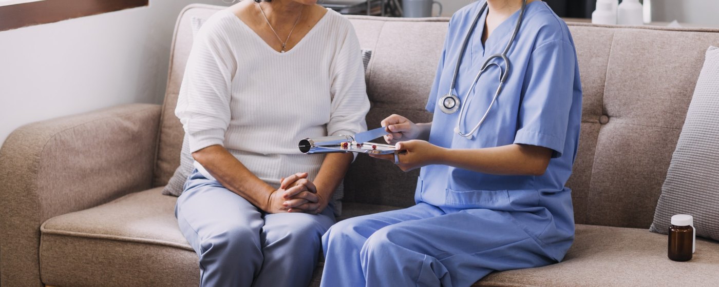 Caregiver reviewing a care plan with a client at home
